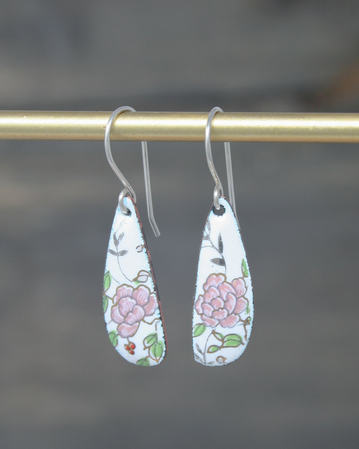 a pair of earrings hanging from a hook