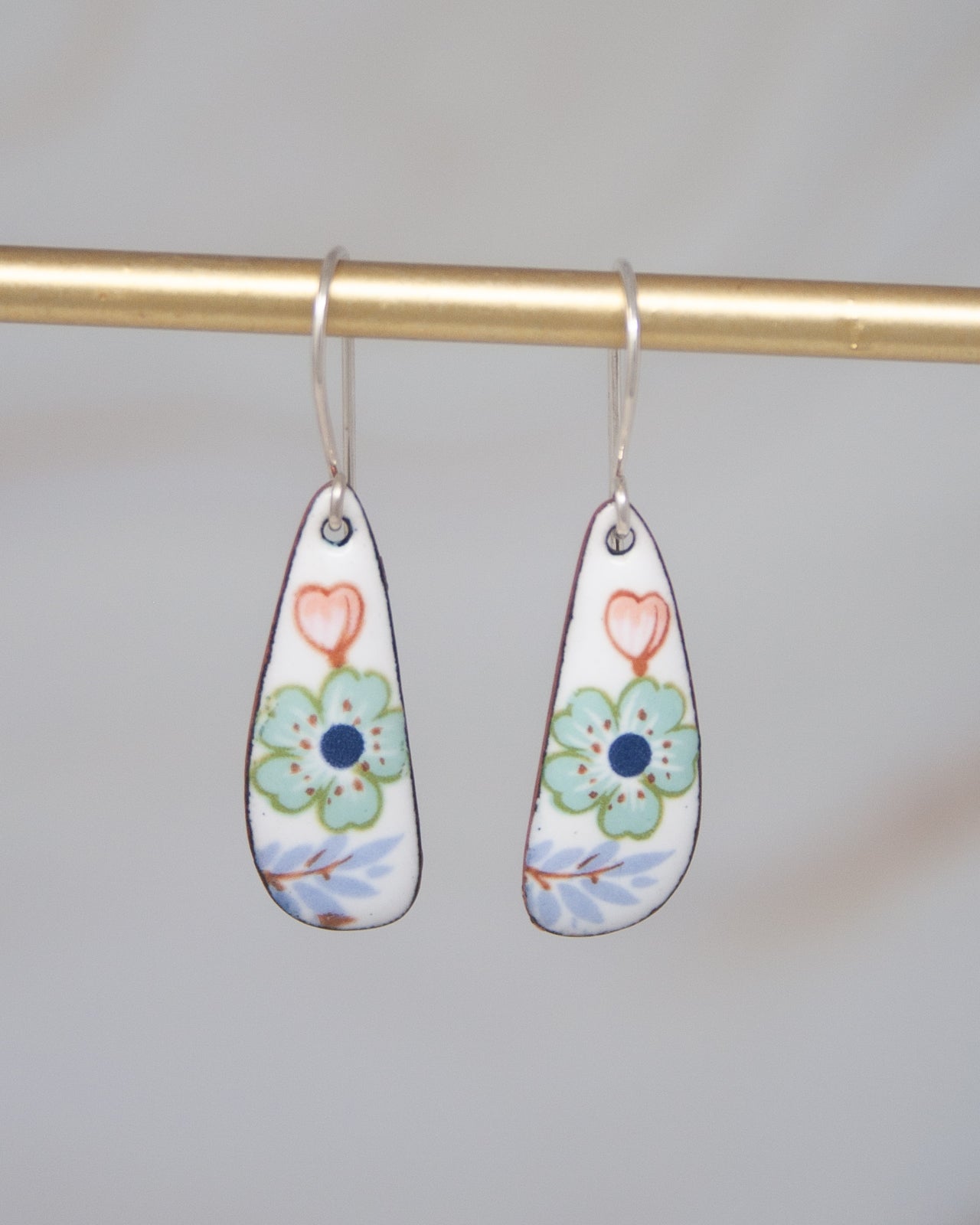 A pair of earrings with a floral design on a white background.