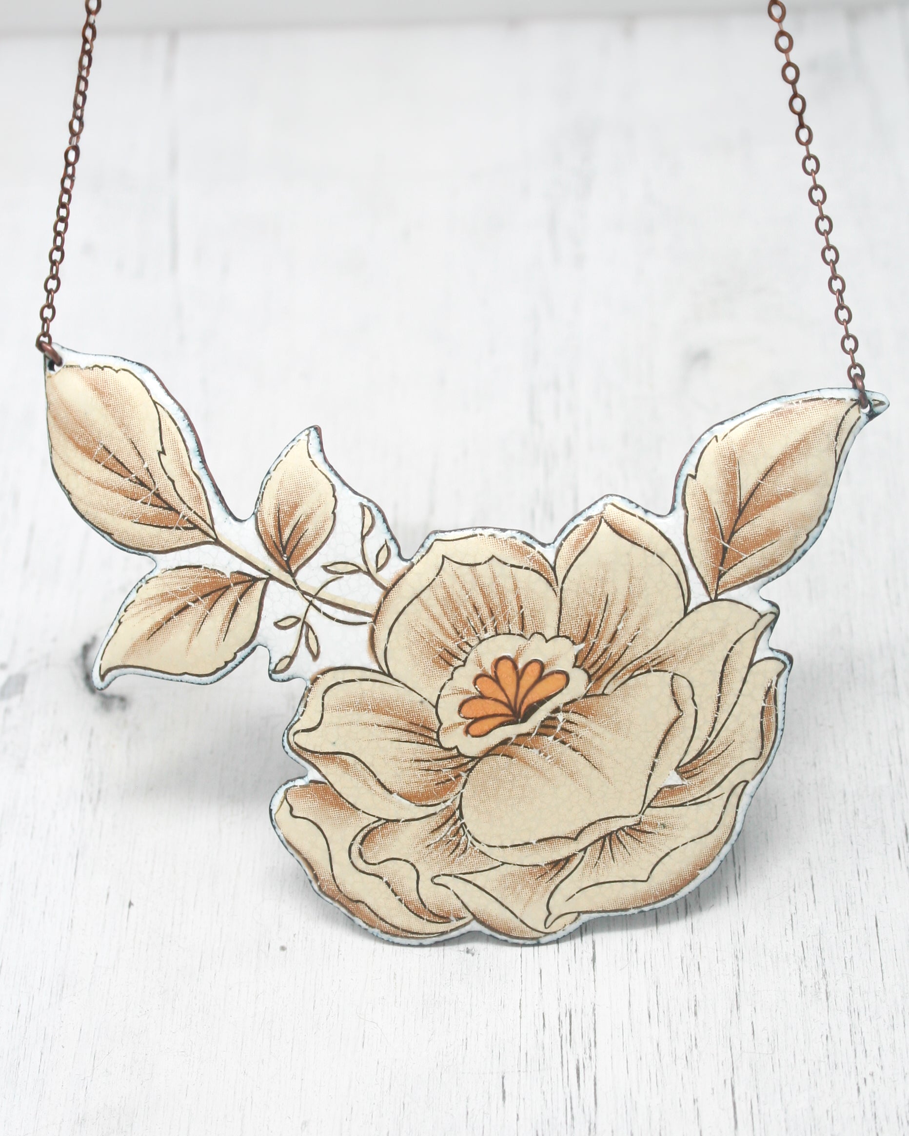 a necklace with a flower painted on it