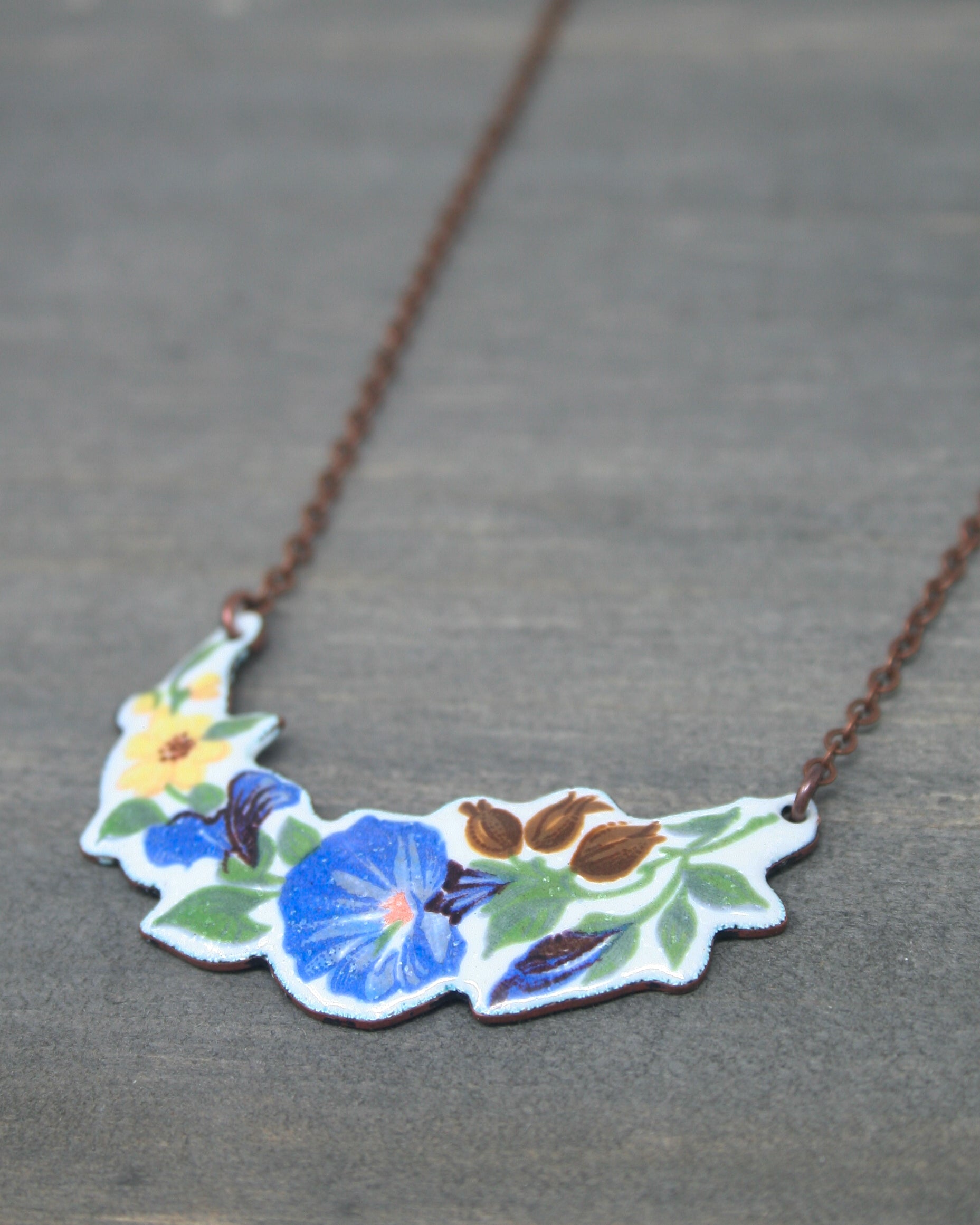 a necklace with flowers painted on it