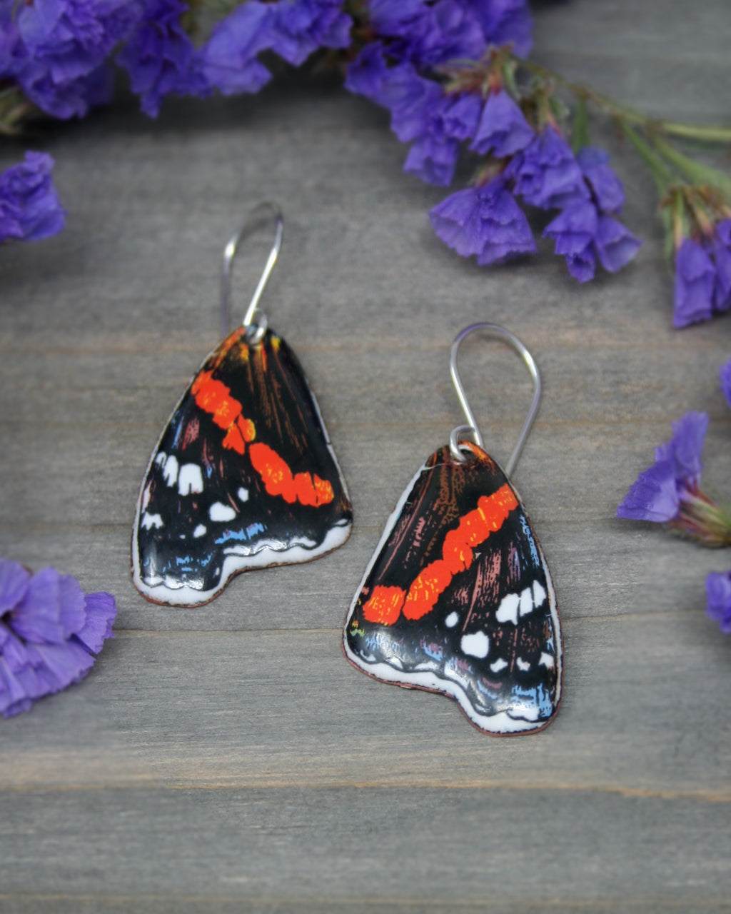 a close up of a pair of butterfly earrings