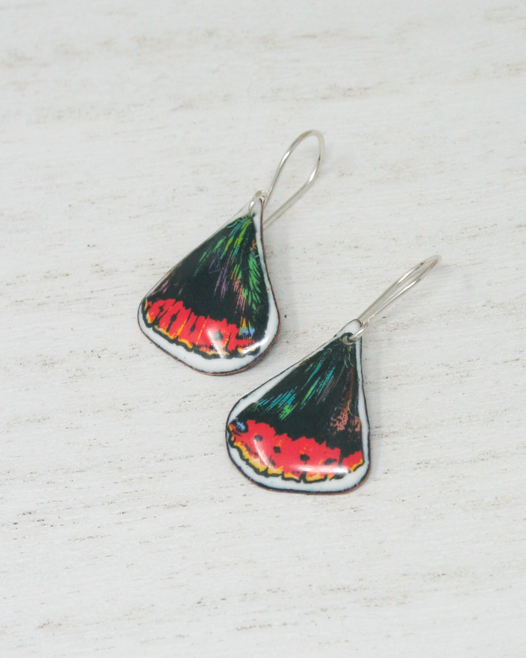 a pair of earrings with a colorful design on them