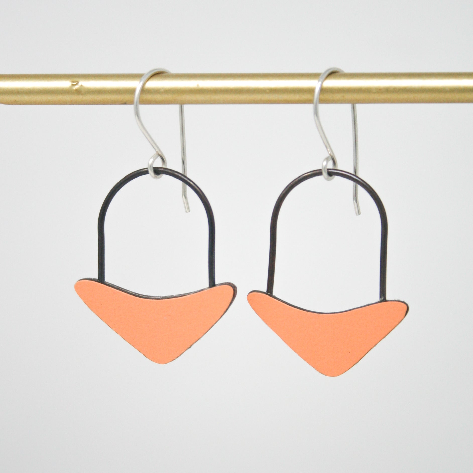 a pair of earrings hanging from a hook