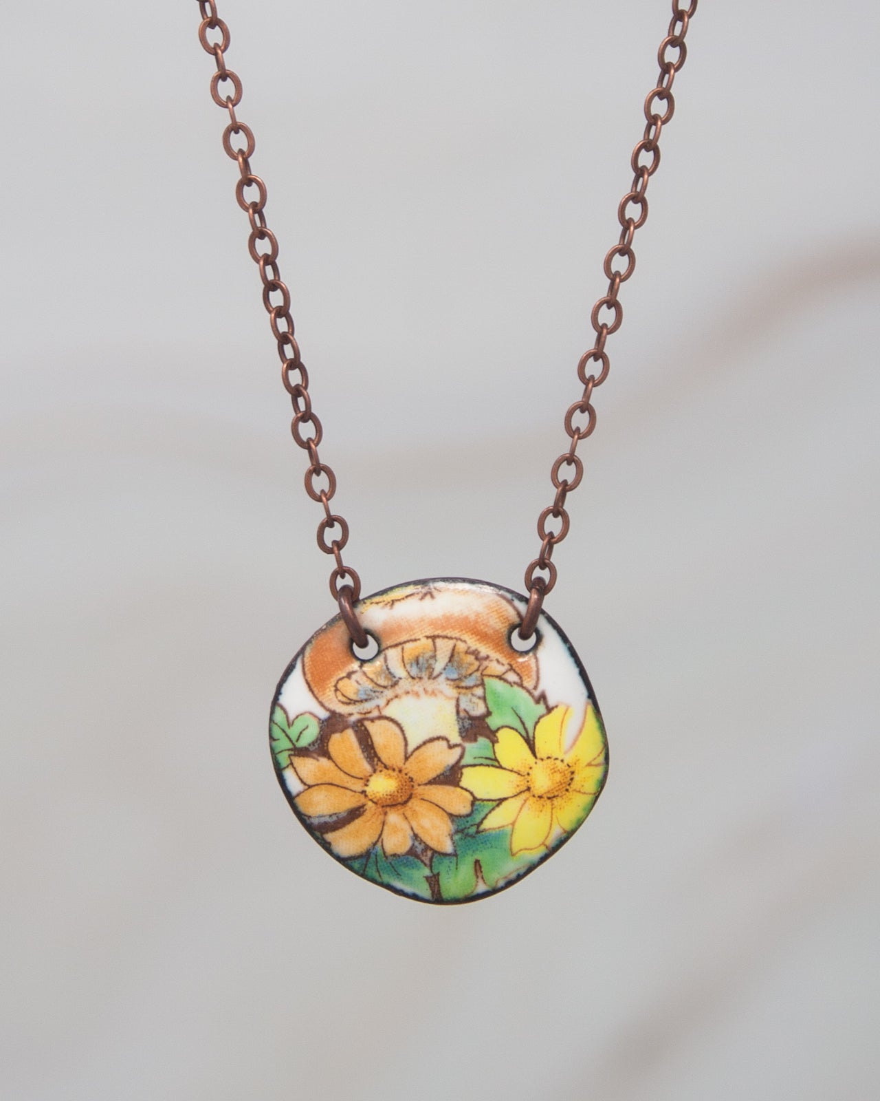 A necklace with a pendant featuring a floral design.