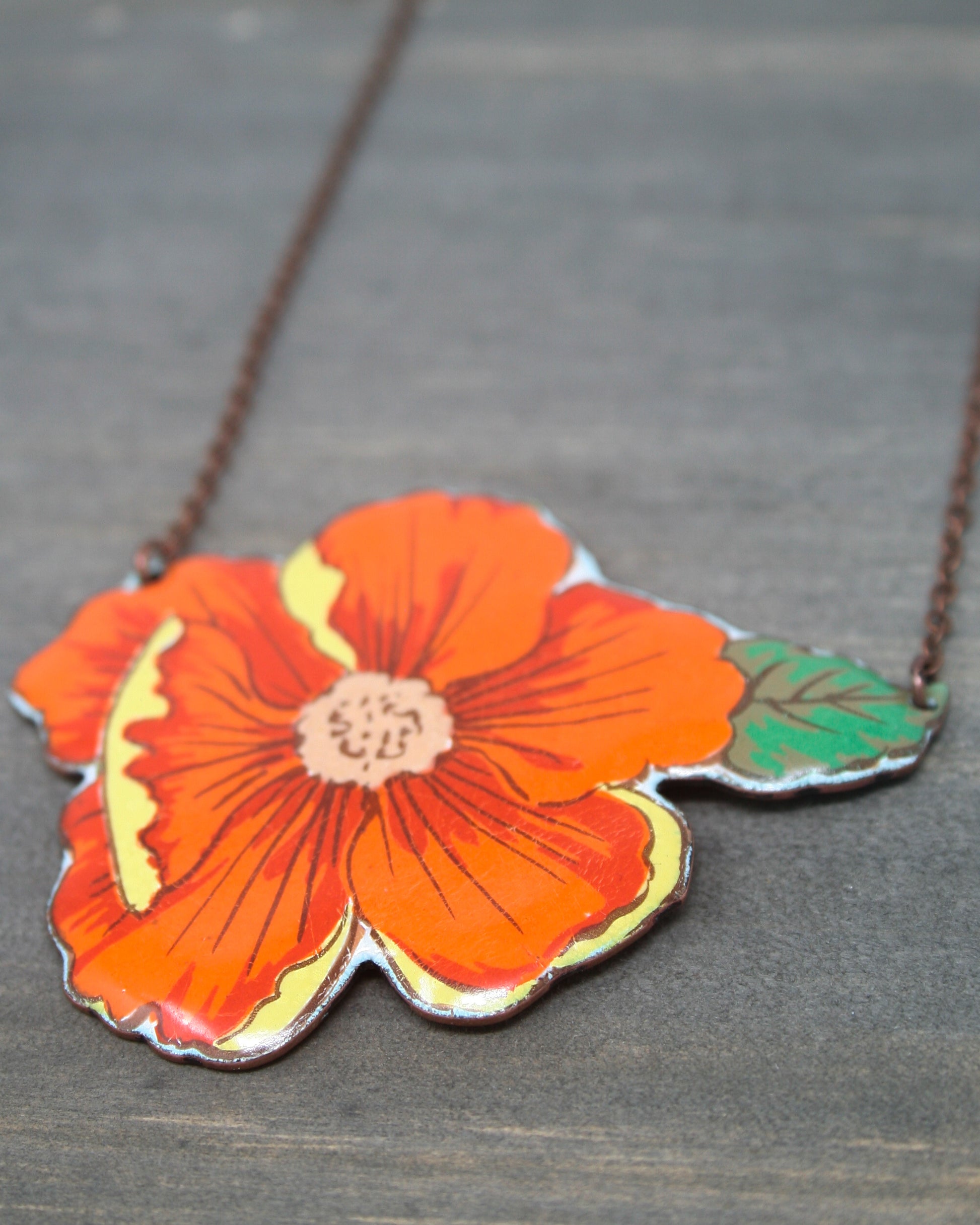 a necklace with a flower on a chain