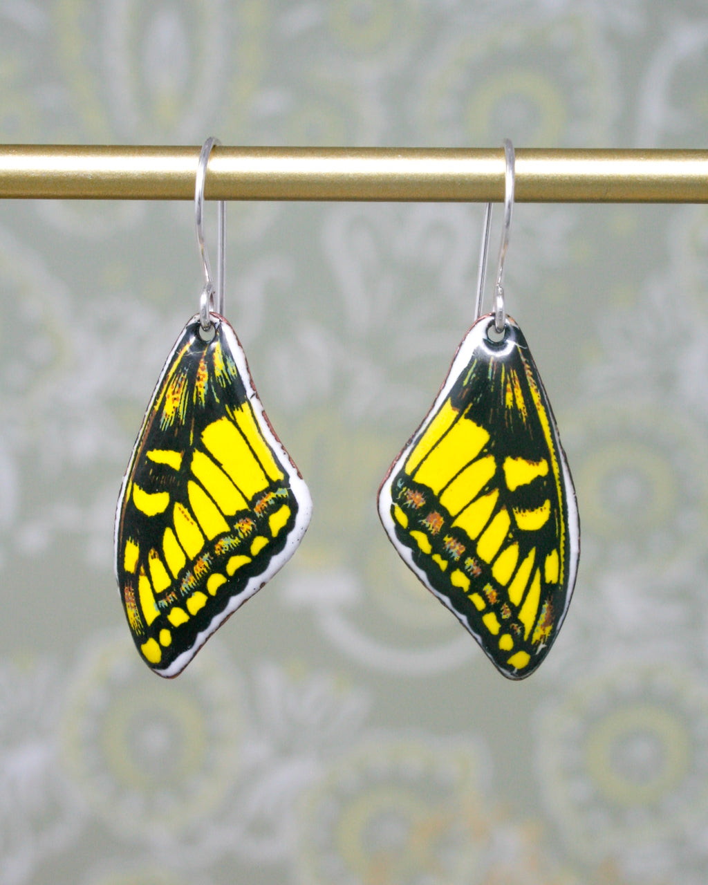 a pair of yellow and black butterfly earrings