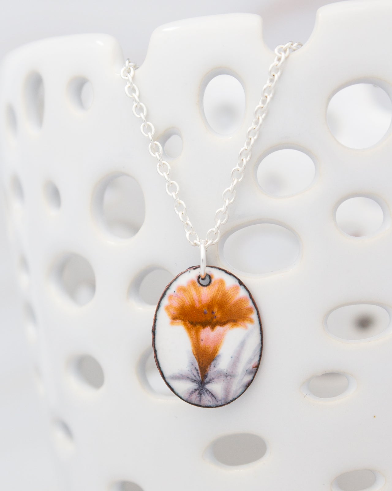 A necklace with a pendant featuring a flower design.