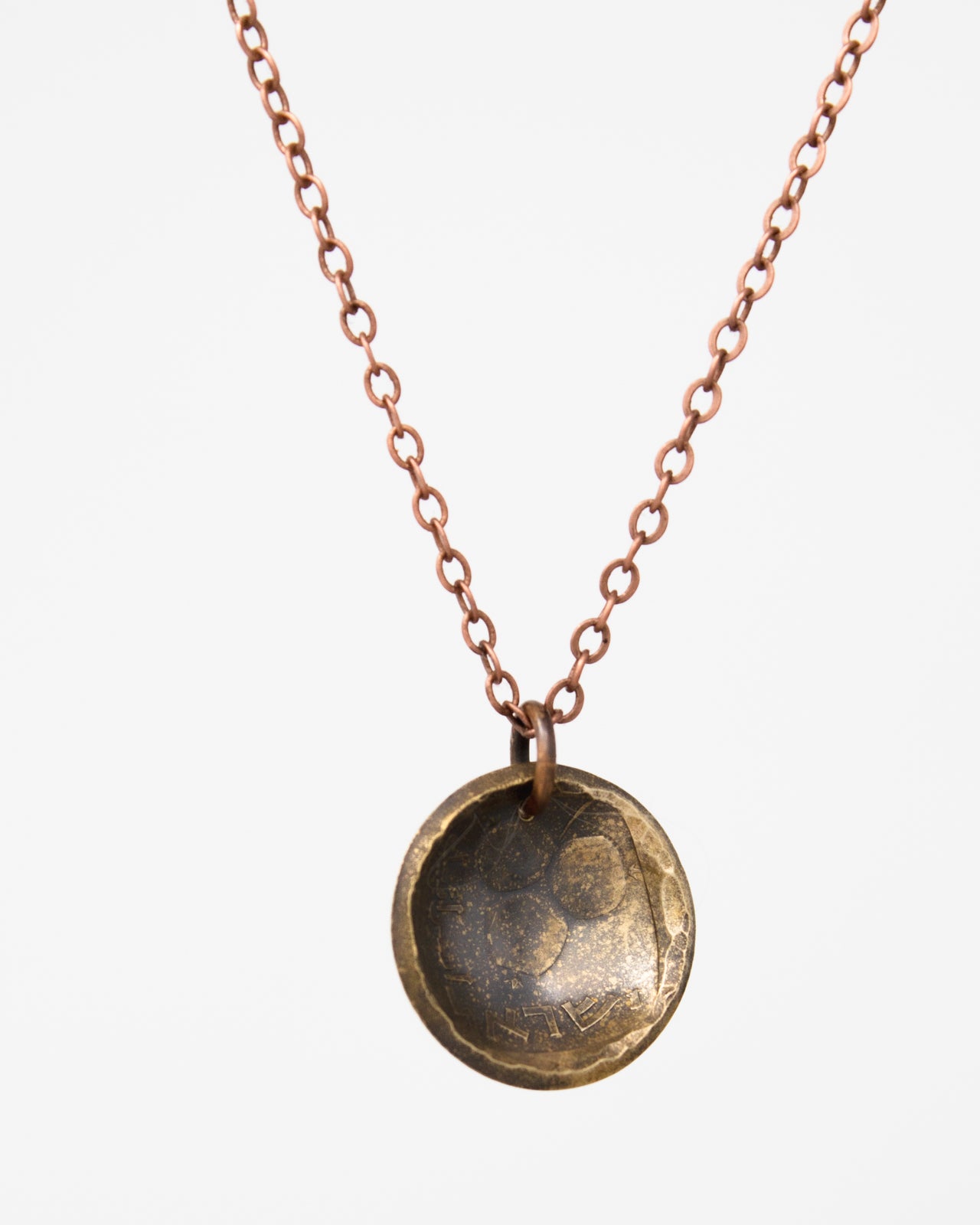 A necklace with a round pendant featuring a design or pattern.