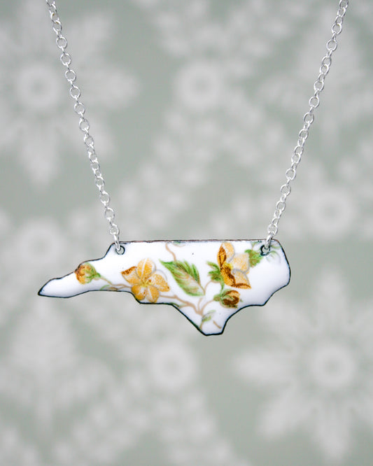 a necklace with a picture of a flower on it