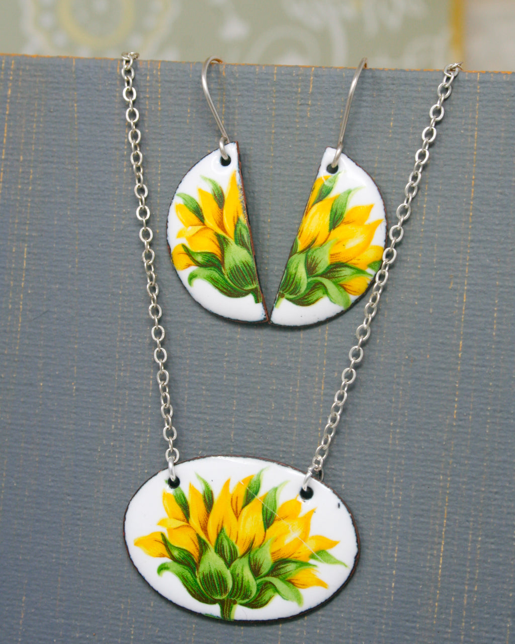 a necklace and earrings with yellow flower designs.
