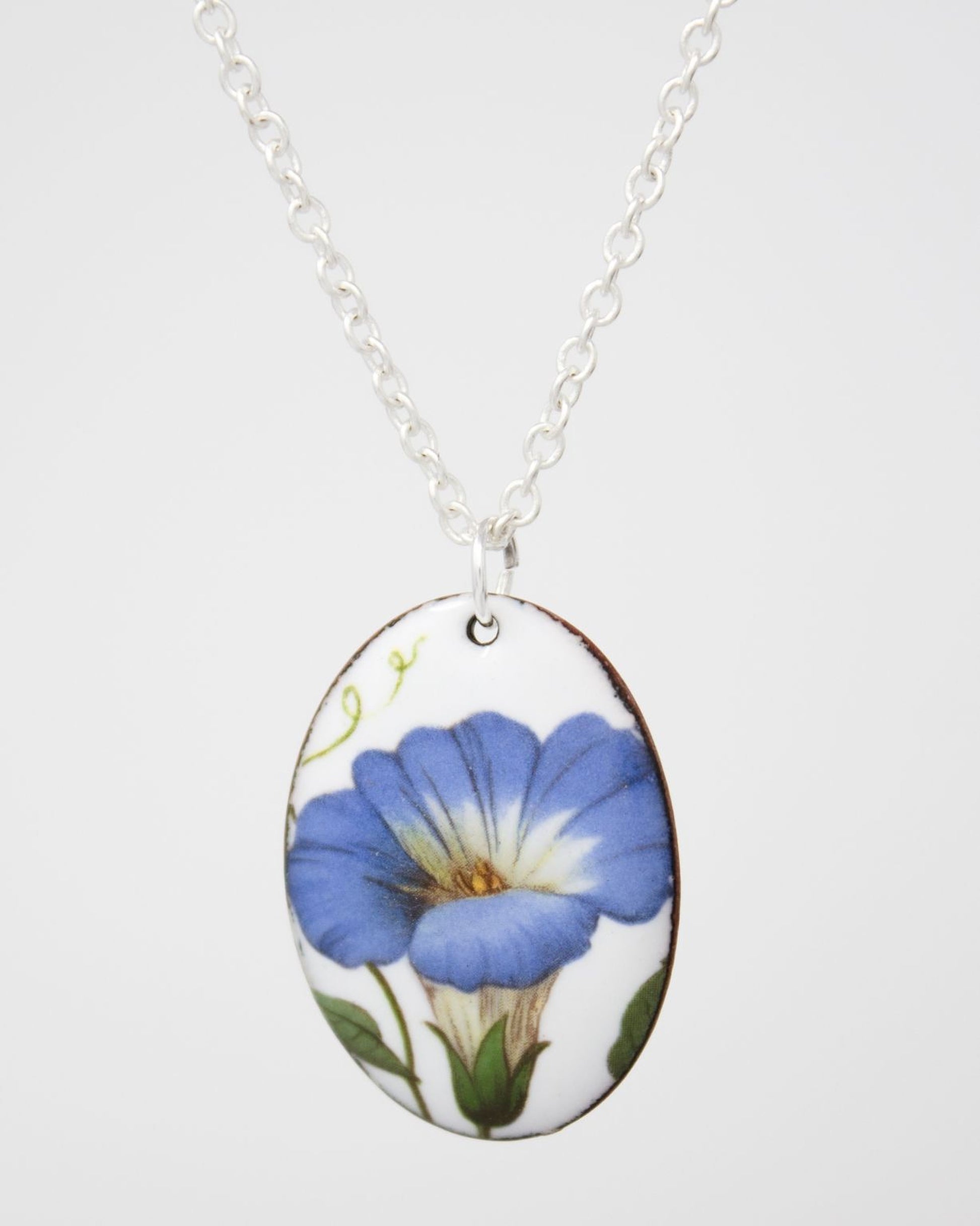 A necklace with a pendant featuring a blue flower design.