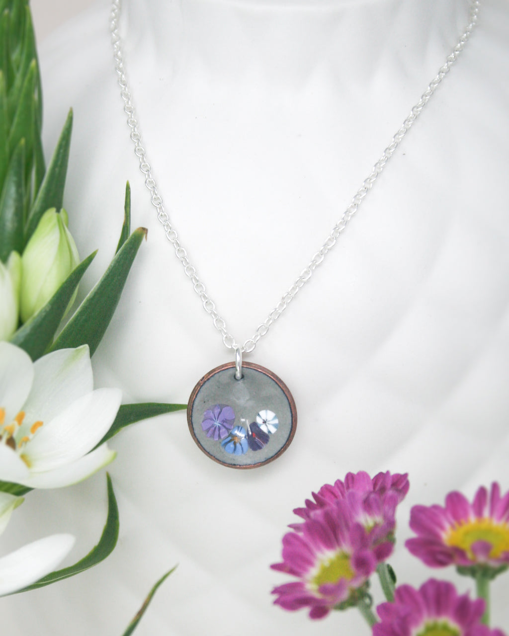 a necklace with a picture of a butterfly on it