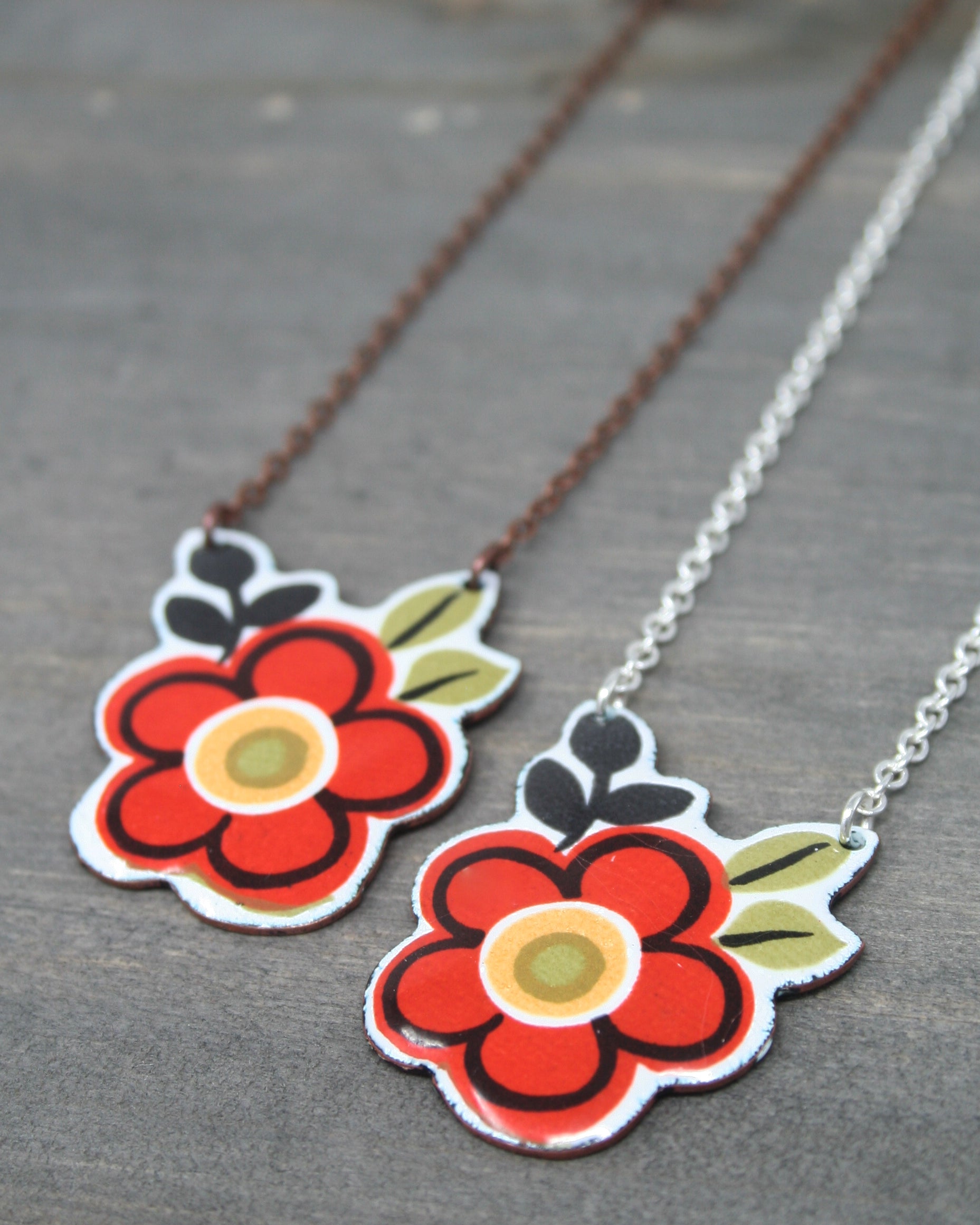 two red flowers are attached to a chain