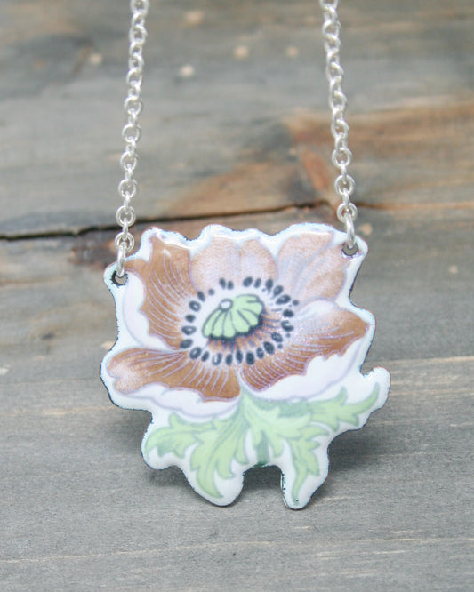 a necklace with a flower painted on it