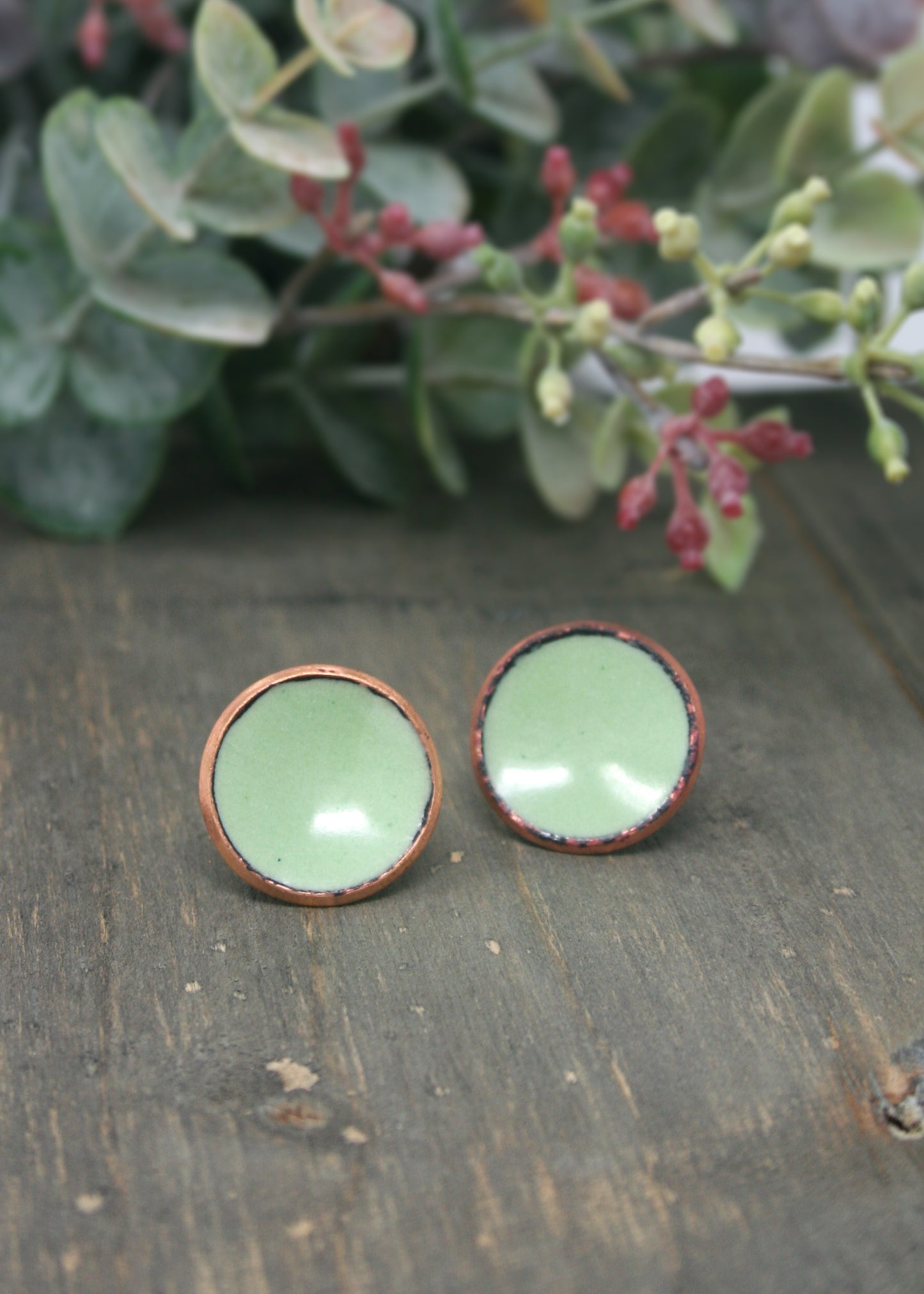 two small green bowls sitting on top of a wooden table