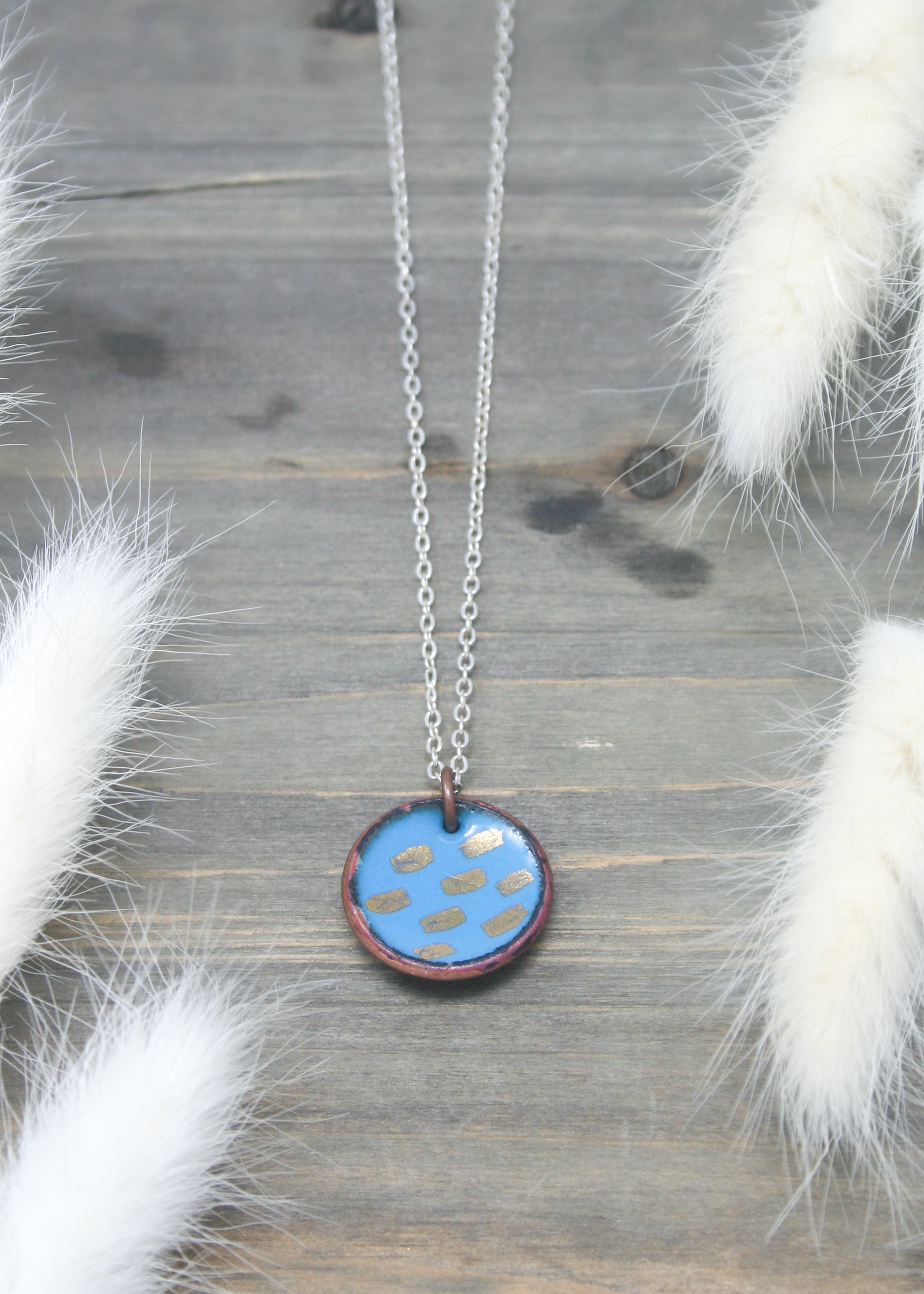 a necklace with a dog paw on it