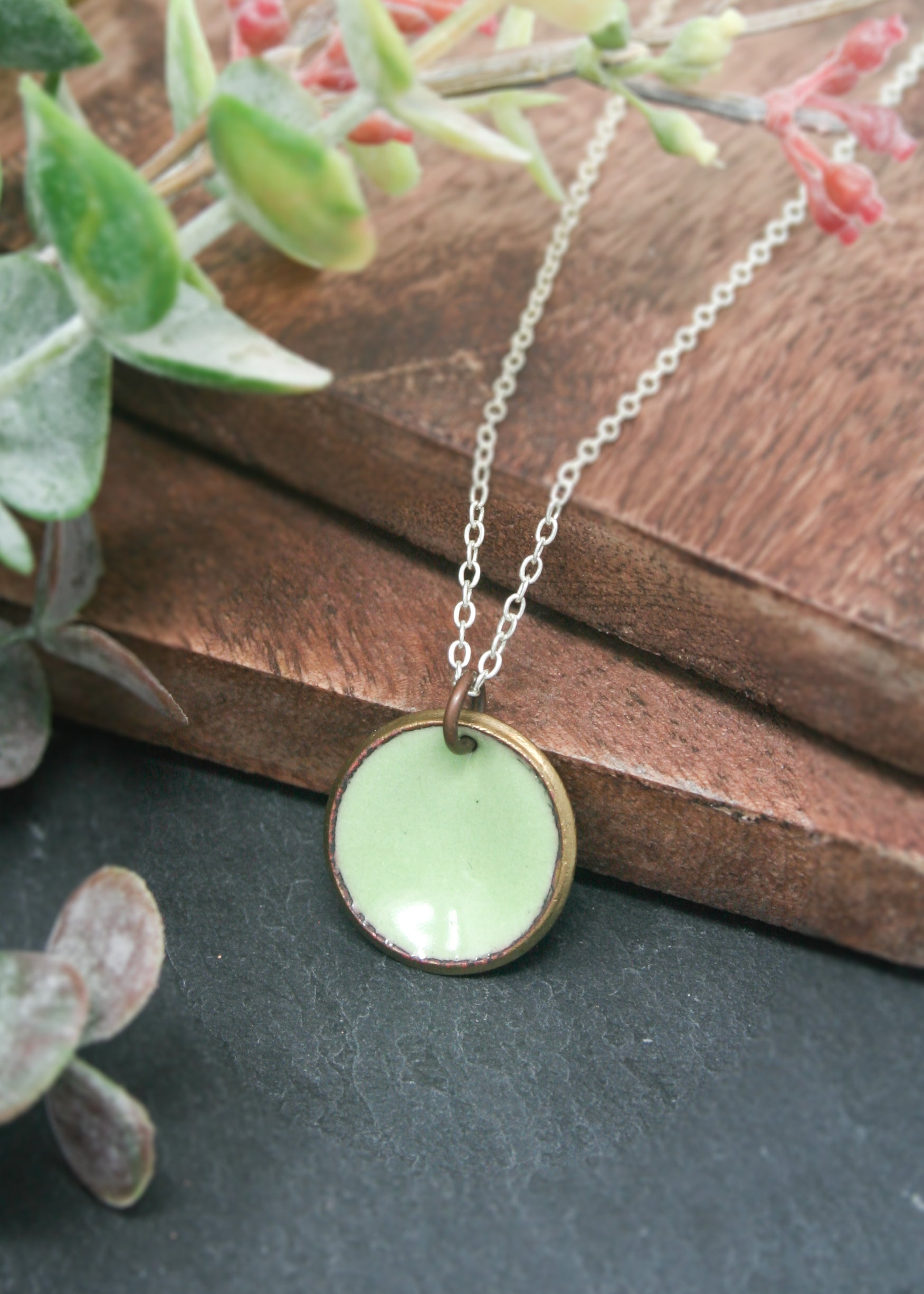a necklace with a green circle on it