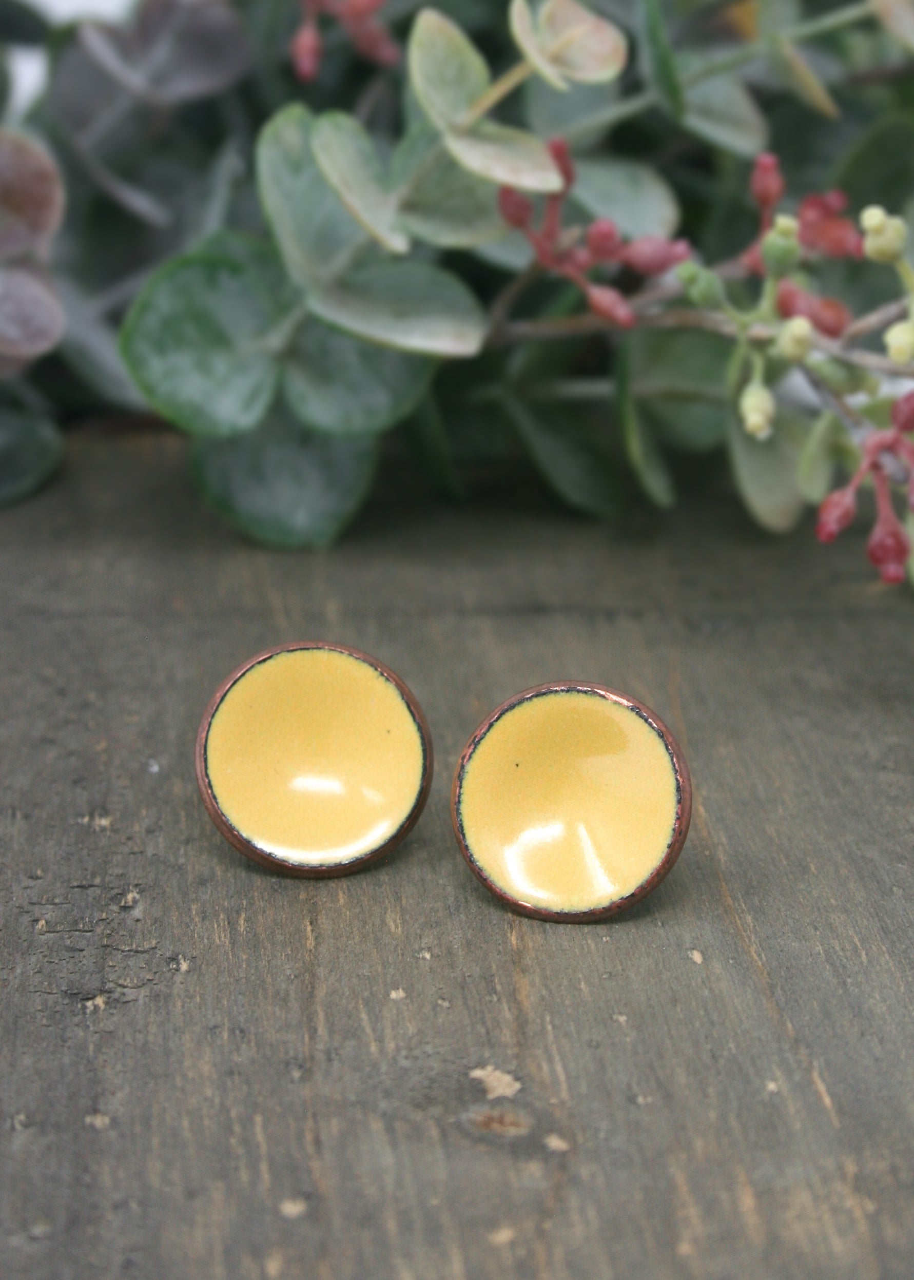two small yellow bowls sitting on top of a wooden table