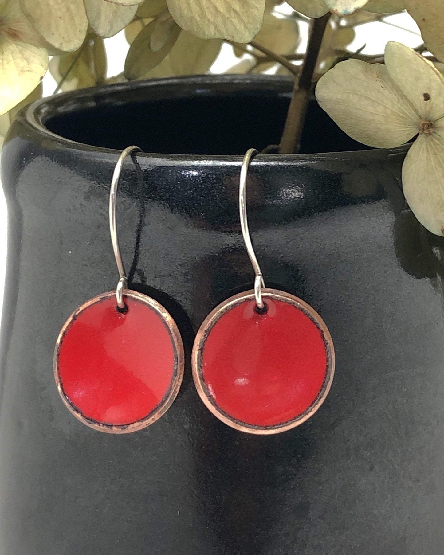 a close up of a pair of red earrings