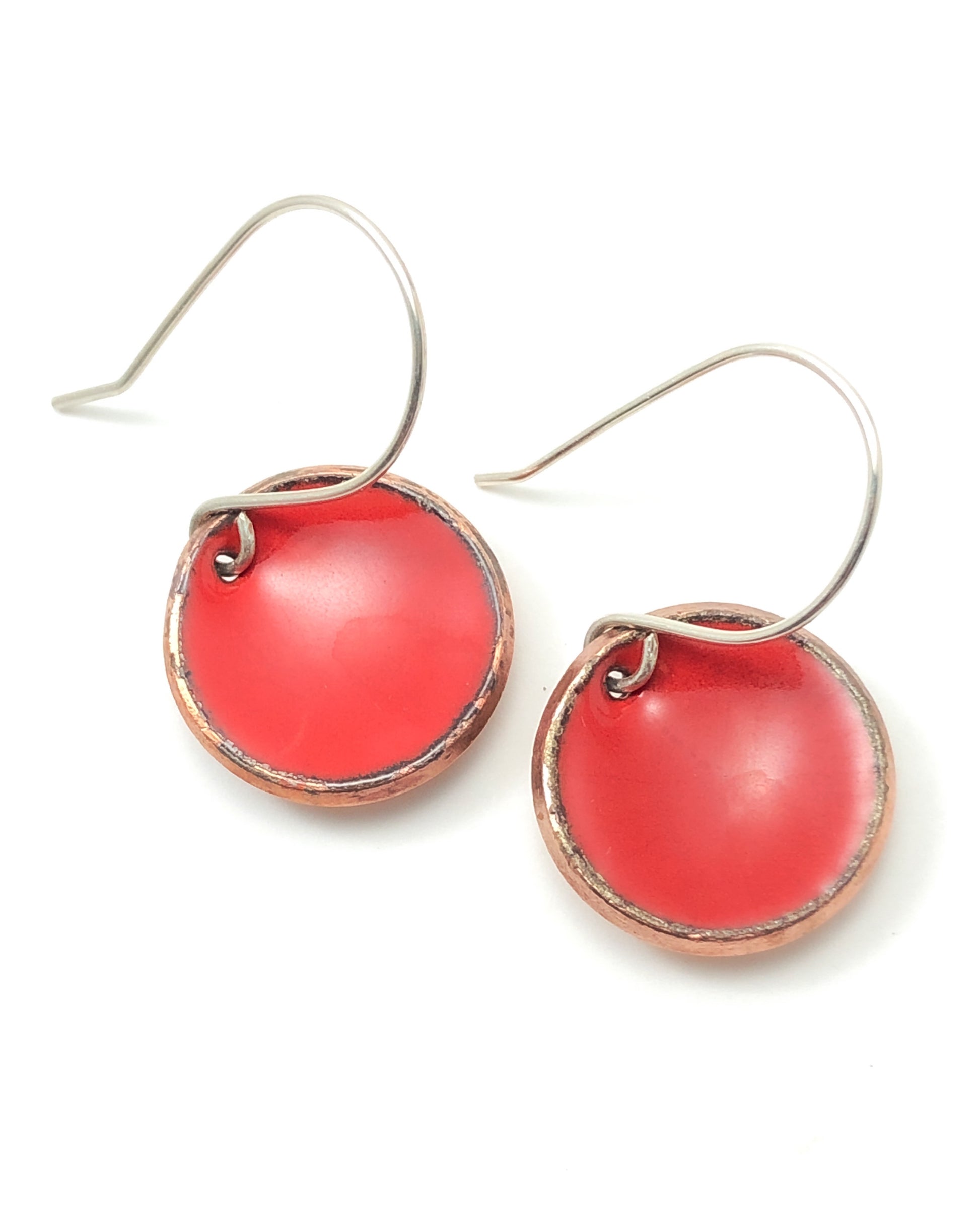 a pair of red earrings on a white background