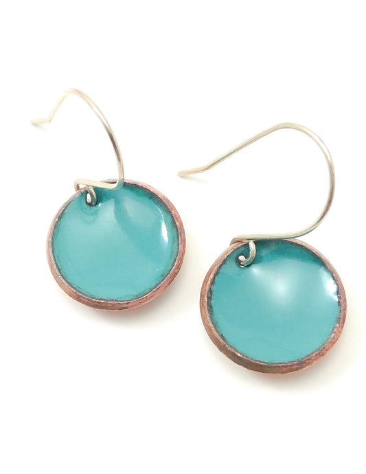 a pair of blue earrings on a white background