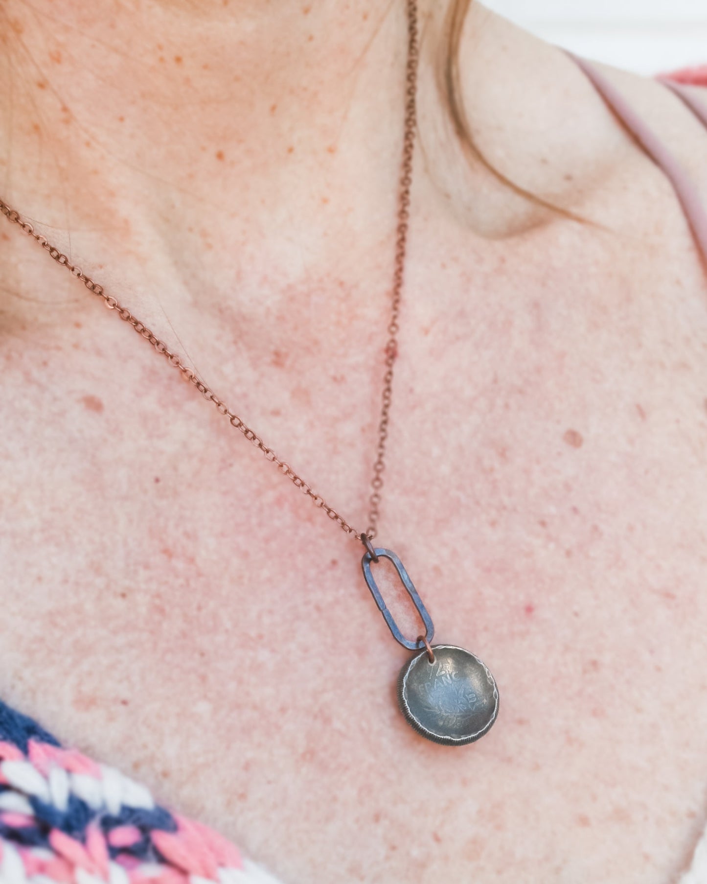 a close up of a person wearing a necklace