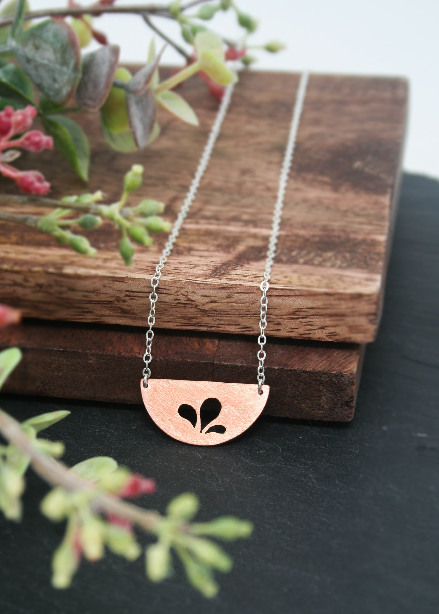a necklace that has a flower on it