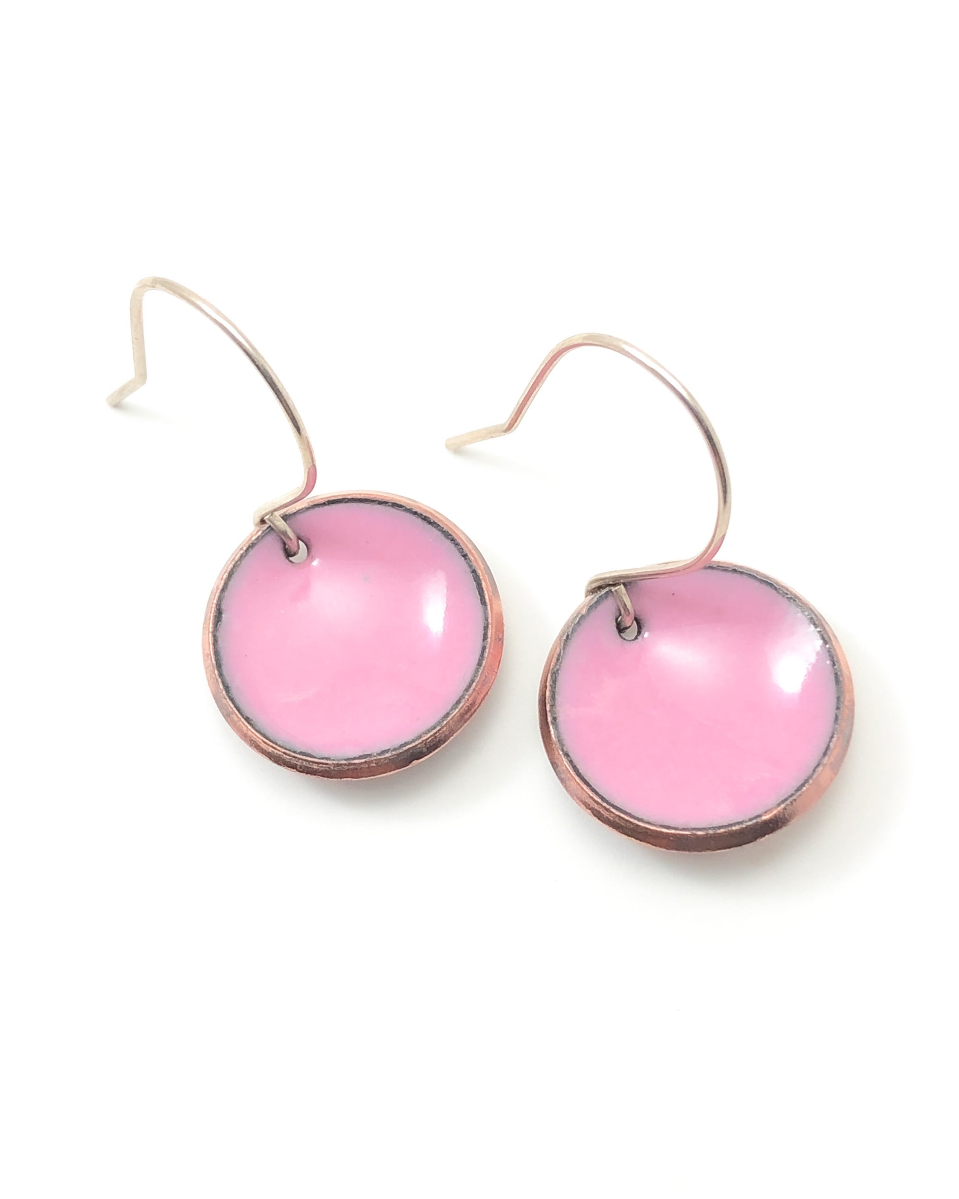 a pair of pink earrings on a white background