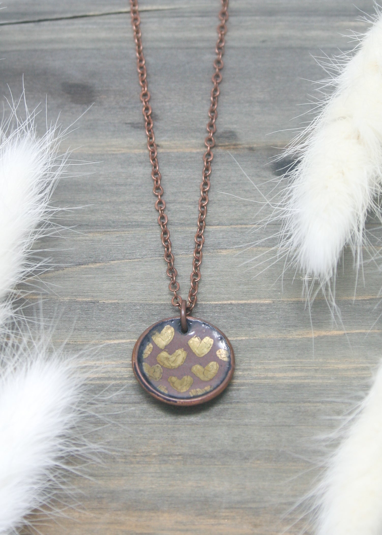 a necklace with a gold heart on it