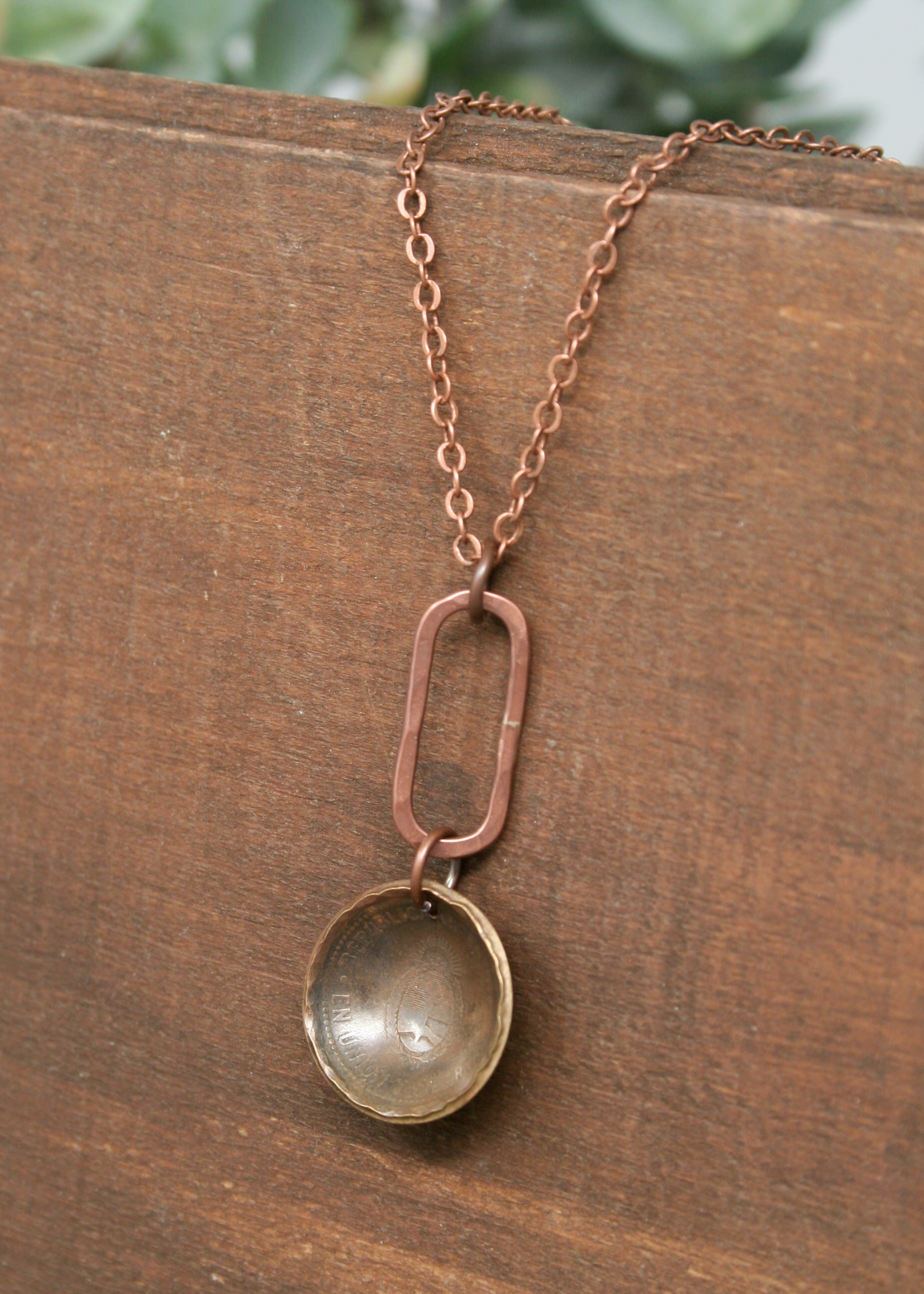 a close up of a necklace on a wooden surface