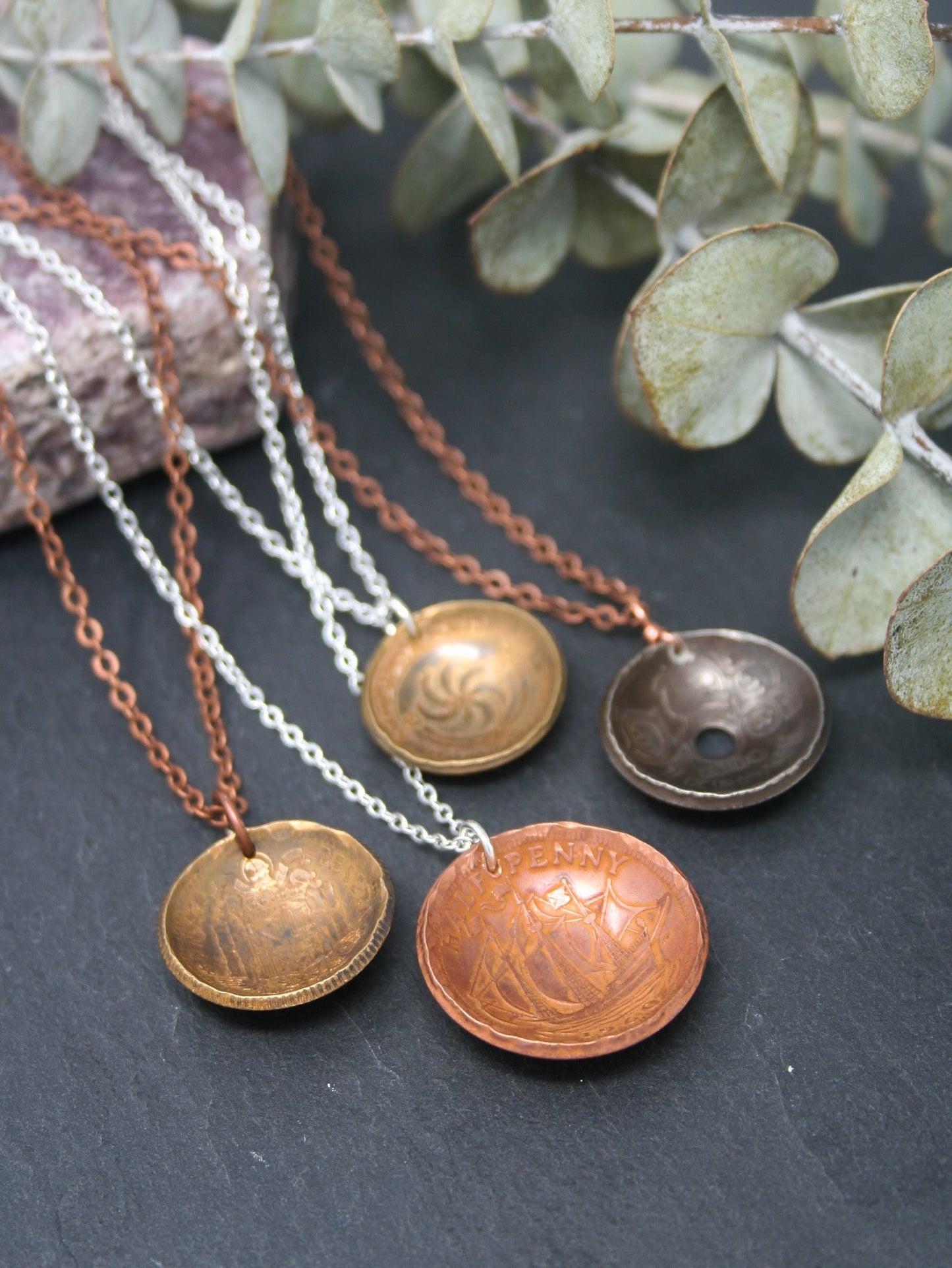 a group of three different necklaces sitting on top of a table