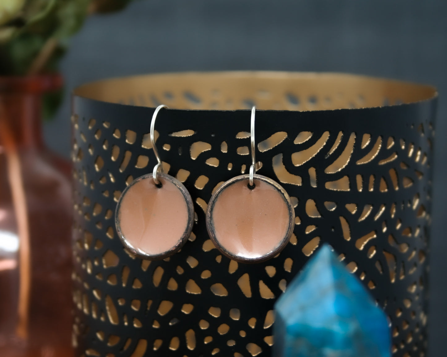 a pair of earrings sitting on top of a table