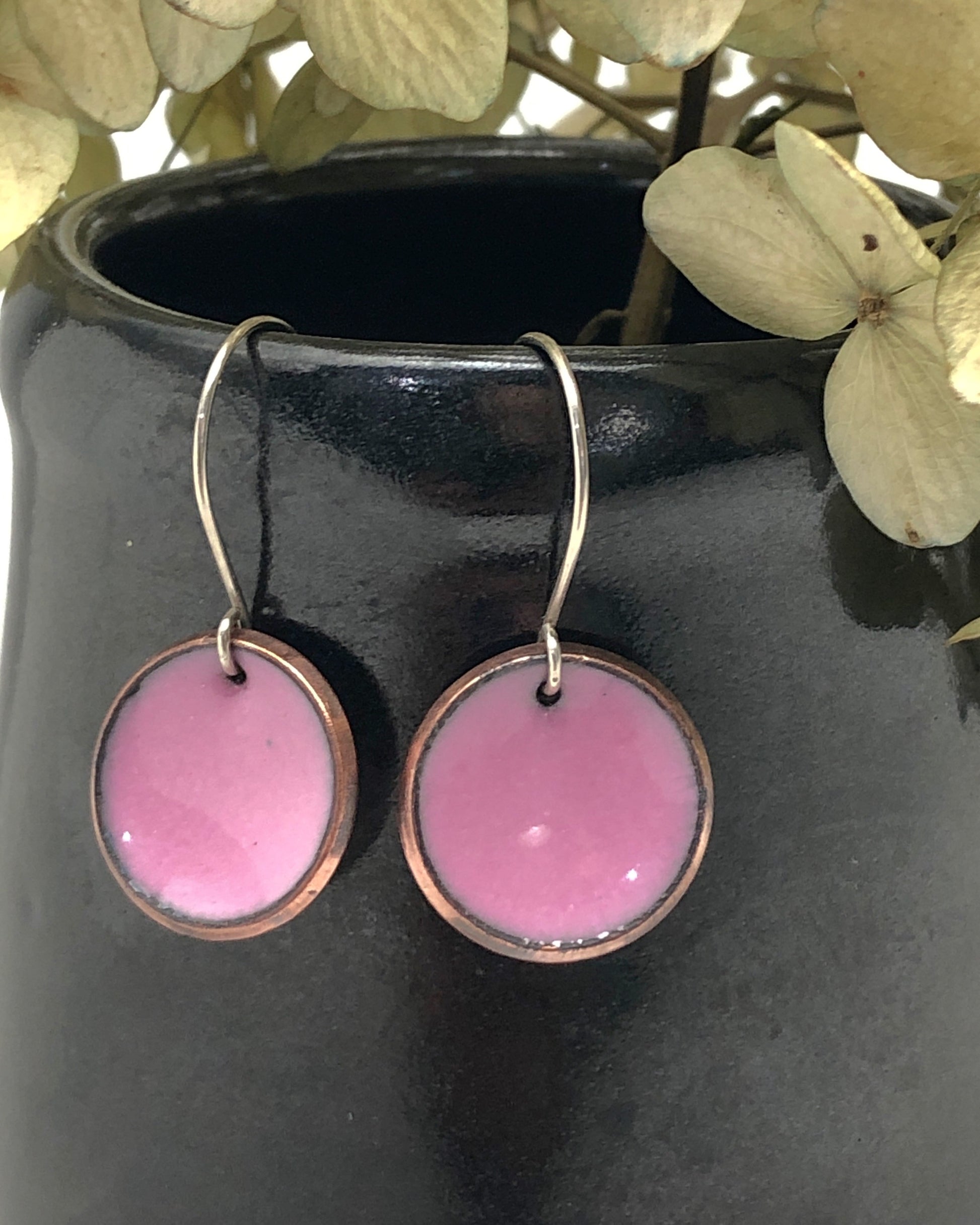a close up of a pair of pink earrings