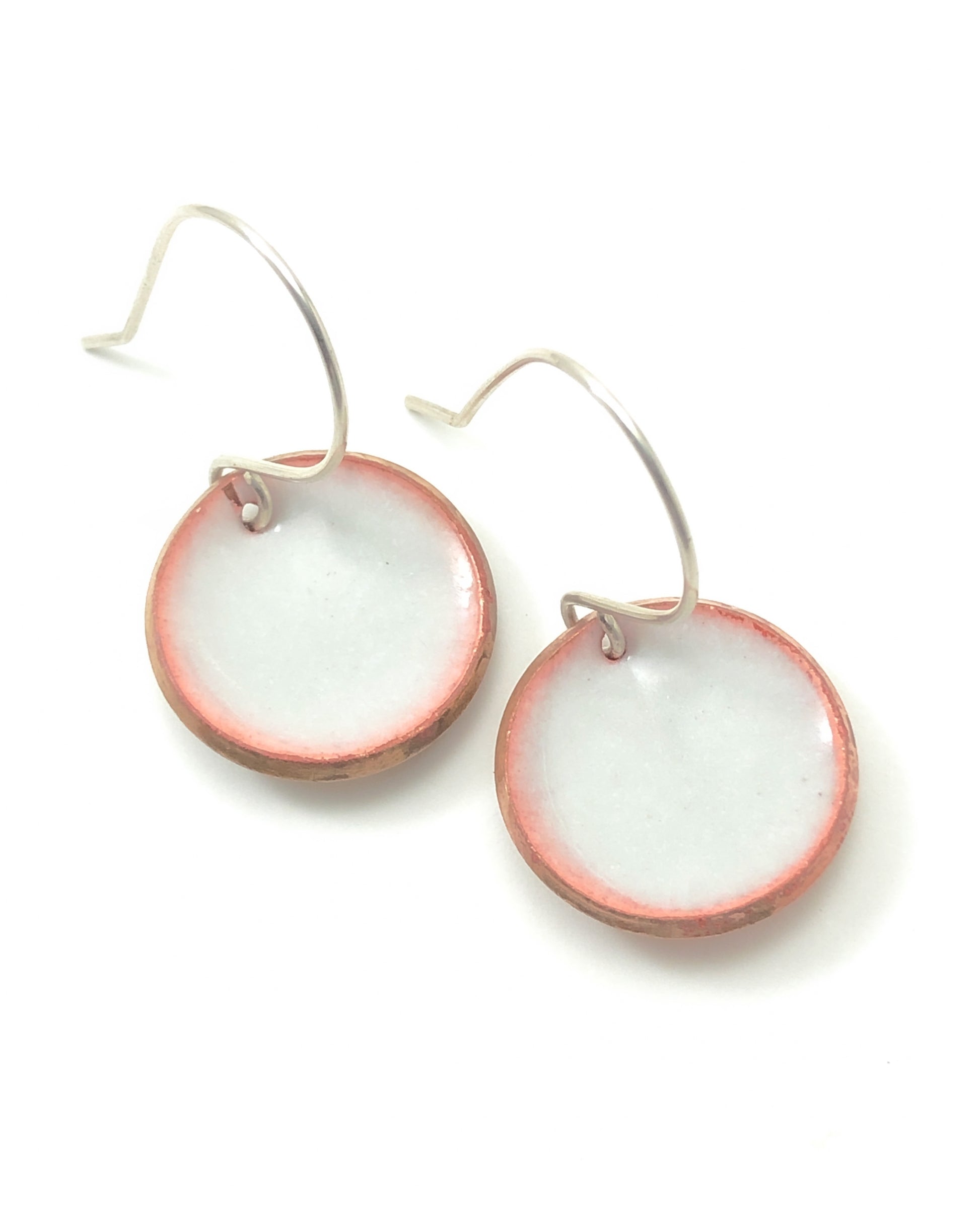 a pair of pink and white earrings on a white background
