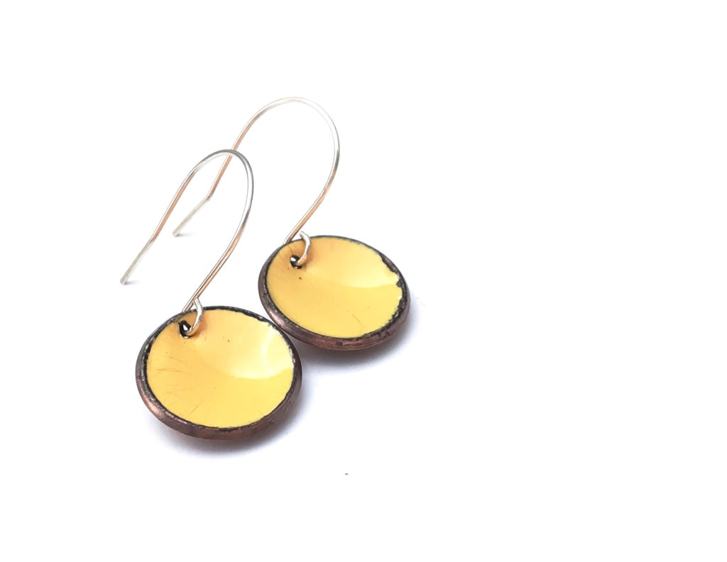 a pair of earrings on a white background