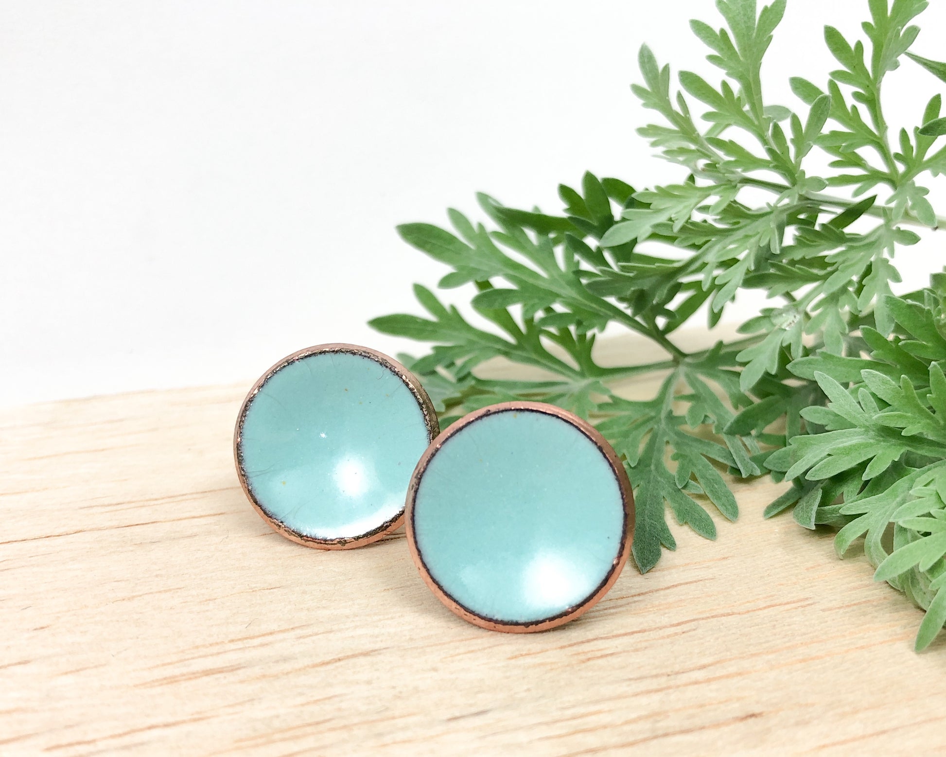 two small blue bowls sitting on top of a wooden table