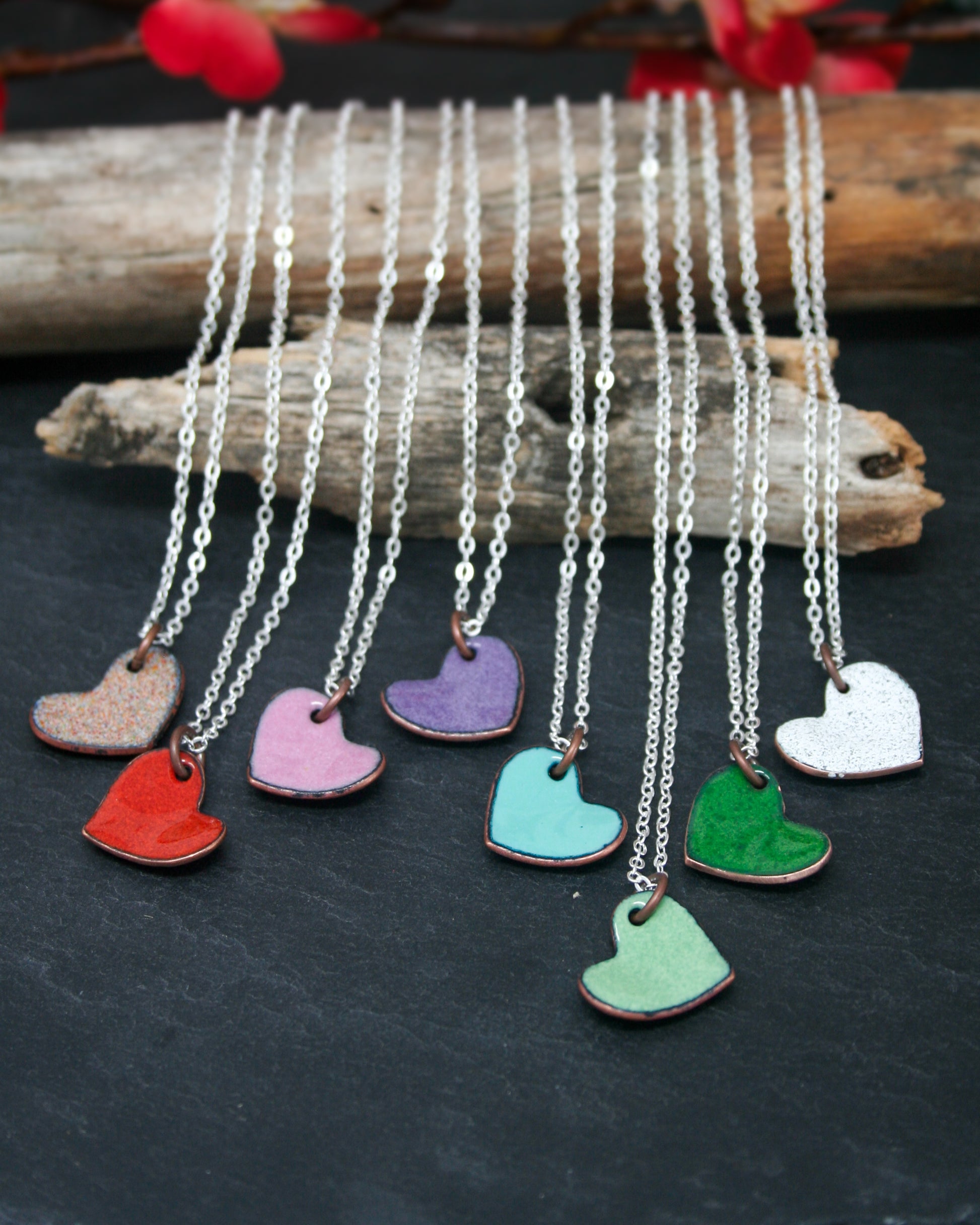a bunch of different colored hearts on a chain